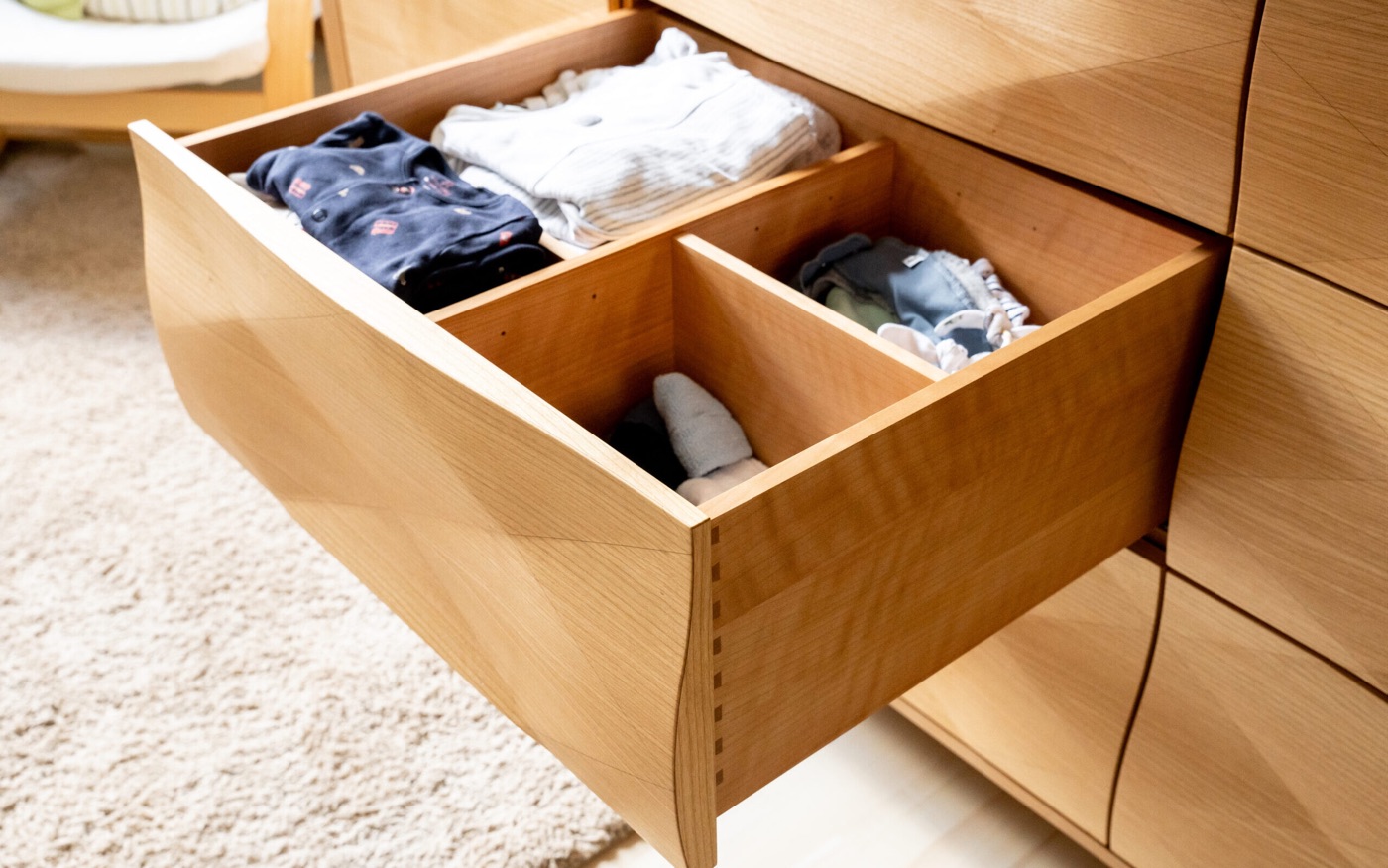 Geöffnete Holzschublade mit Fächerteilung im Detail